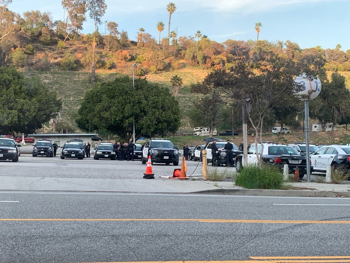 PplsCityCouncil's tweet photo. LAPD staging near Echo Park Lake. Under the direction of the city of Los Angeles and @MitchOFarrell, the cops are going to raid the Echo Park Lake encampment and evict hundreds of residents of the park. 

We can see what the city is doing. ALL EYES ON ECHO PARK TONIGHT https://t.co/YgZKNRhshW