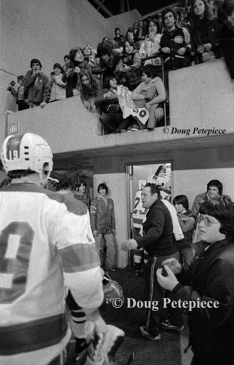 TheUnrealDougP's tweet photo. #CornwallRoyals One of the few times I remember Royals star Danny Geoffrion (right) being injured_photographed standing outside team dressing room at #CornwallCivicComplex. Trainer Ray Moquin is also in the shot. As most nights in the 1970's the stands were packed https://t.co/hQGIs6sR3q