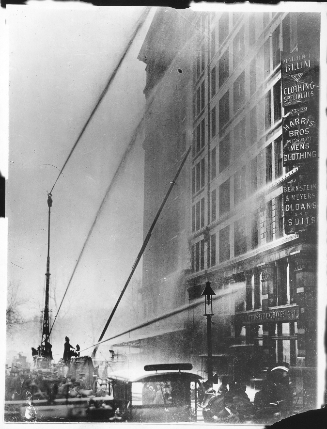 A fire truck sprays water at the 10-story-high Asch Building. The fire truck’s ladder reaches ineffectually up to the 7th floor--the fire started on the 8th floor. 