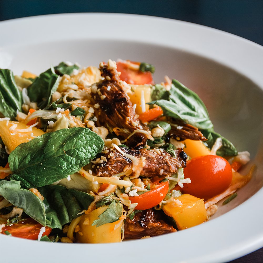 RumbaRumBar's tweet photo. Salad Goals. Back on the menu &amp; one of our favorites—Thai Steak &amp; Noodle Salad with island-marinated #steak, pancit #noodles, #sriracha lime vinaigrette, #mango, #avocado, #tomatoes, #peanuts, and toasted #coconut. #RumbaHamptonBays #thaisteakandnoodlesalad #eeeeeats #RumbaVibes https://t.co/t3vZ98OFjN