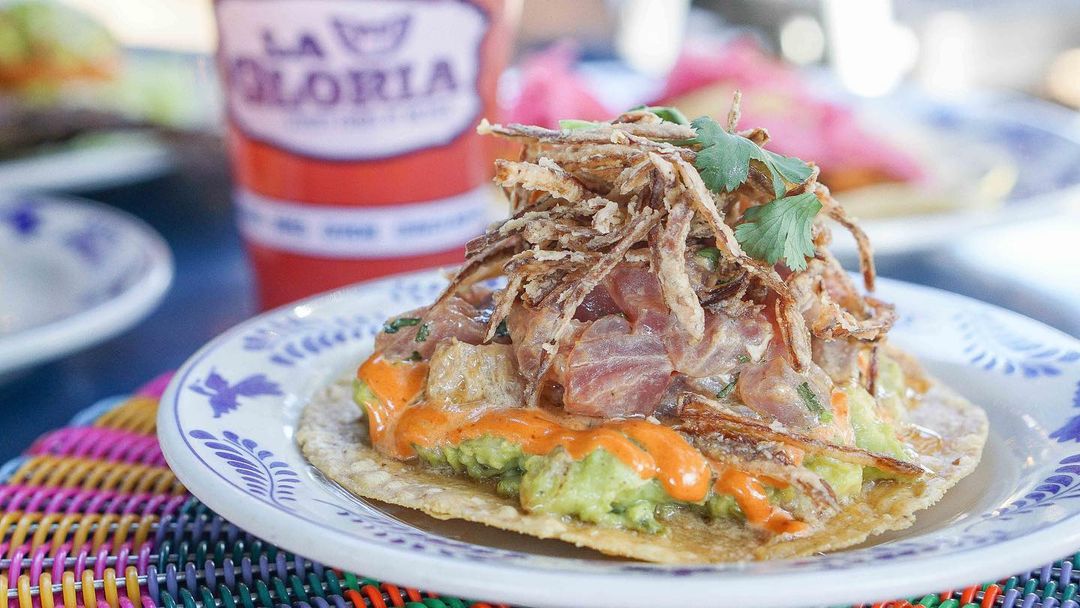 Pull up a chair on La Gloria's patio to try a new addition to their menu. Stacked tall, the Tostada de Atún features fresh tuna, mashed avocado, chipotle dressing and leche de tigre.