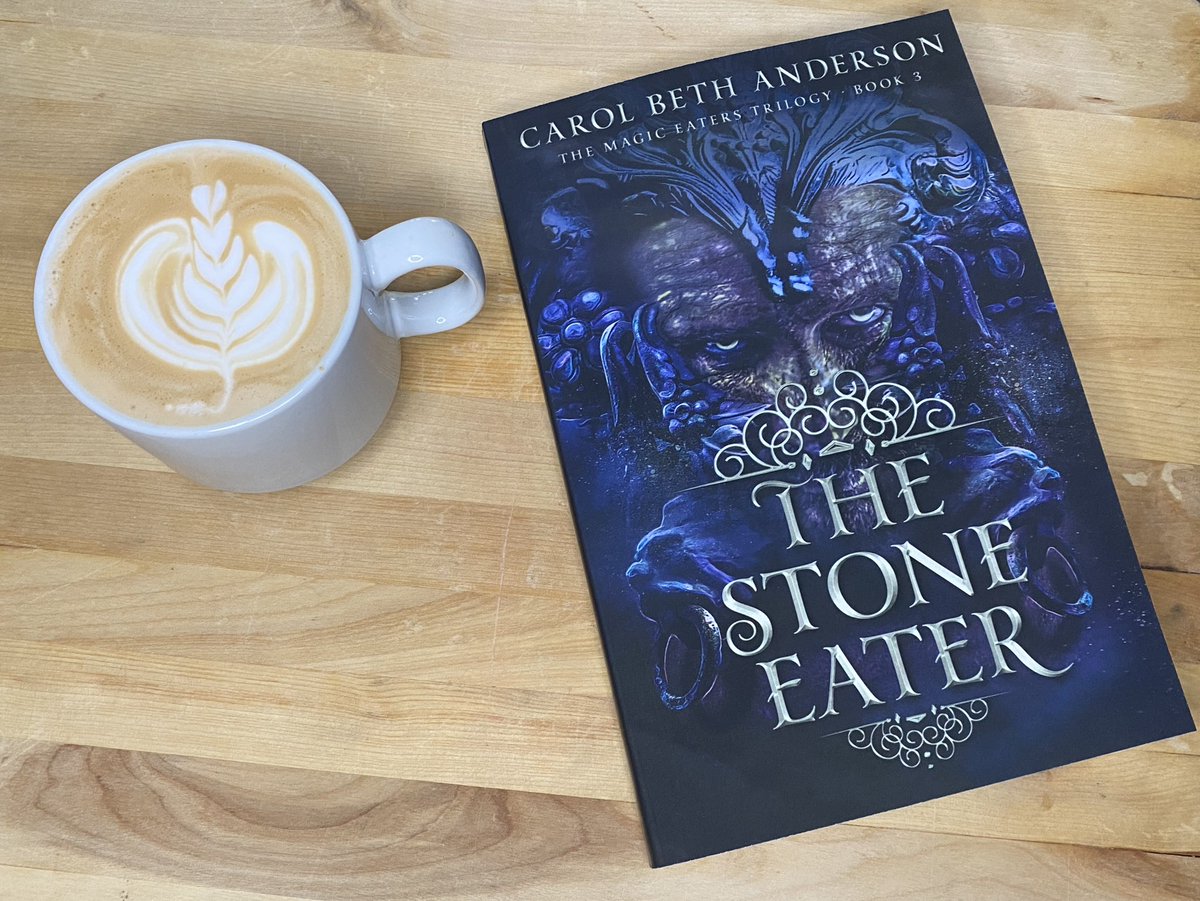 The Stone Eater paperback next to a pretty latte