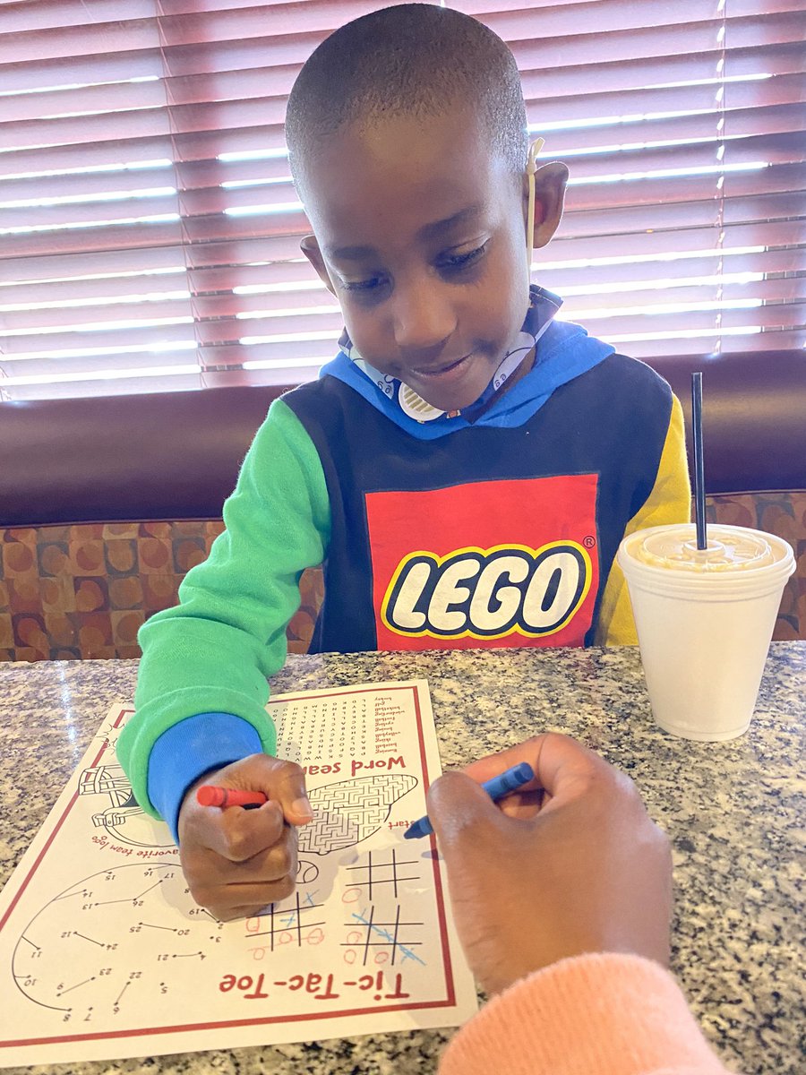 My handsome lunch date kicking my butt in some Tic-Tac-Toe!