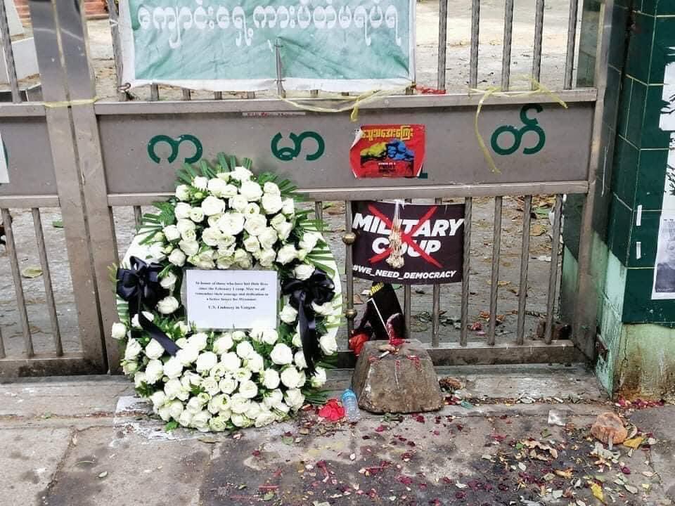 hninyadanazaw's tweet photo. Scornfully abusive, disrespectful. The wreath placed by US embassy Yangon honoring Myanmar protestors who have lost their lives, at the spot of one young protestor was killed, was taken away by junta’s secutiry forces a moment later this morning. 
#WhatsHappeningInMyanmar https://t.co/HKs110A86m