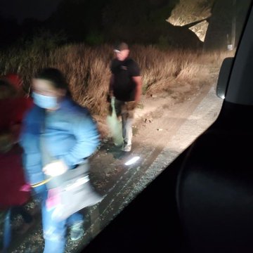 Immigrants who just crossed the border at night following the arrows to the processing facilities. 