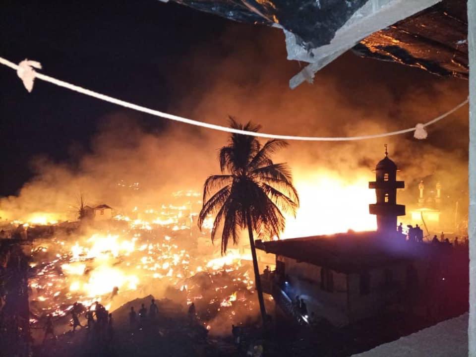 WharfKids's tweet photo. Desperately sad - huge fire ripped through Susan’s Bay two nights ago. Not Magazine Wharf thankfully, but are tragic reminder of the fire risks in these unplanned and overcrowded housing areas. Thoughts with all those affected. https://t.co/SNF96XF6Kn