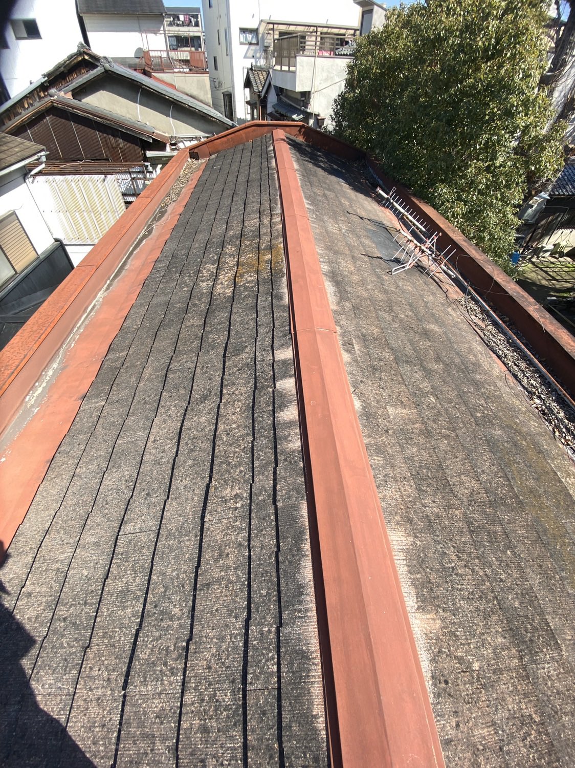 大野板金店 パラペットカラーベスト屋根改修工事 大阪府大阪市東成区 雨漏りの為カラーベスト屋根をカバー工法でガルバリウム鋼板立平葺を施工しました 谷樋の排水口が落ち葉でつまるのでステンレス 網を加工し取付けしました 立平葺 雨漏り 屋根