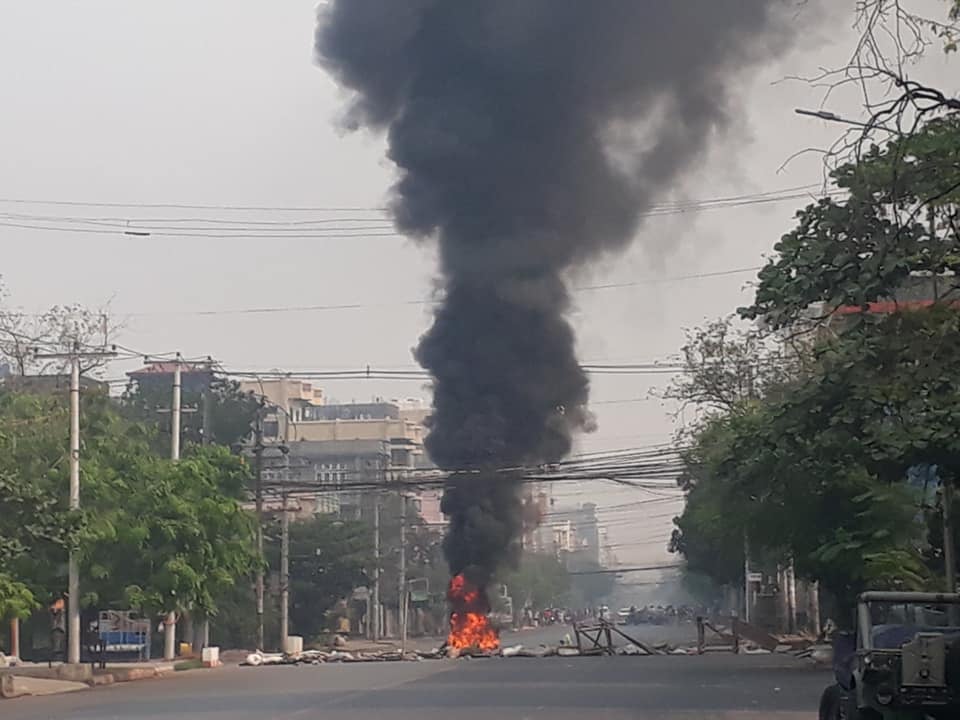 IrrawaddyNews's tweet photo. Tires burned on Mandalay’s roads on Mar. 27. As the military regime celebrates Armed Forces Day in Naypyitaw, people across the country are protesting against the military dictatorship with the cry “Let’s all gather in revolt against Fascism.” (Photo: CJ) #WhatsHappeningInMyanmar https://t.co/6kLu5nFoLF