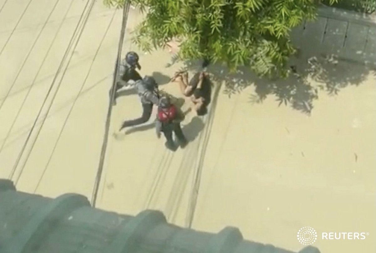 Myanmar officer runs to kick a man lying on the street in Sanchaung, Yangon, Myanmar #WhatsHappeningInMyanmar