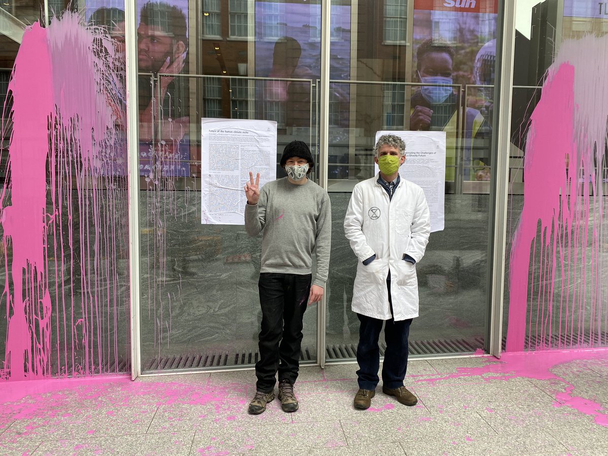 .@CharlieJGardner & @MikeLW90 plastered scientific papers on the windows of News Corp & threw paint. Both arrested on suspicion of criminal damage, as part of #ScientistRebellion actions in more than a dozen countries 25th-28th #ClimateAction #DeedsNotWords