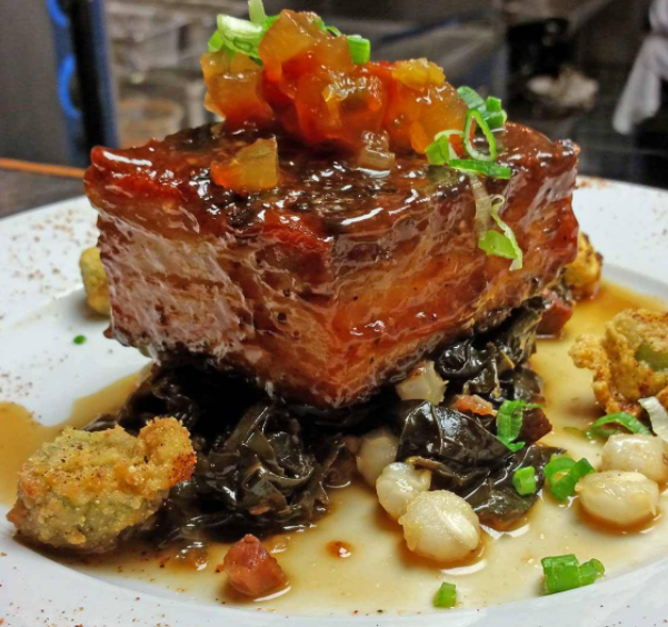 Mississippi Style Barbeque Pork Belly: A little bit of sweet, a little bit of savory, a whole lot yum! 🍴✨
dEATS ➡️ Slow cooked Cheshire pork glazed with our homemade barbeque sauce served with southern cooked greens &amp; hominy, fried okra &amp; watermelon rind relish