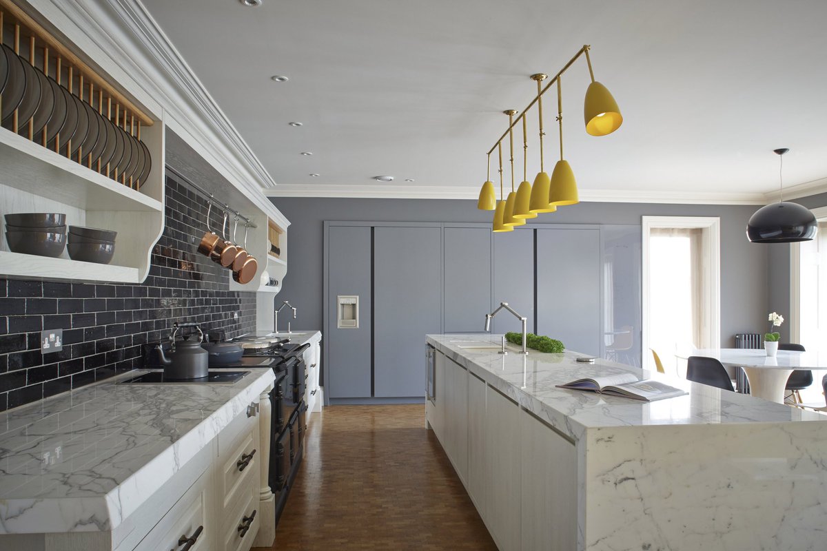 Modern luxury sits seamlessly alongside traditional design in this bright and beautiful kitchen. The super-sized marble counters give a contemporary edge to shaker style cupboards, along with pops of colour and dark accents. 
#chamberfurniture #bespokefurniture #interiorstyling