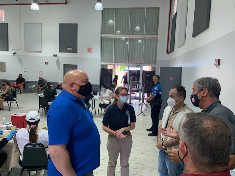 Local officials and Regional Administrator stand in group facing one another