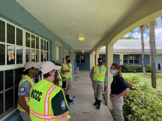 Group of AmeriCorps NCCC members stand facing Administrator Szczech