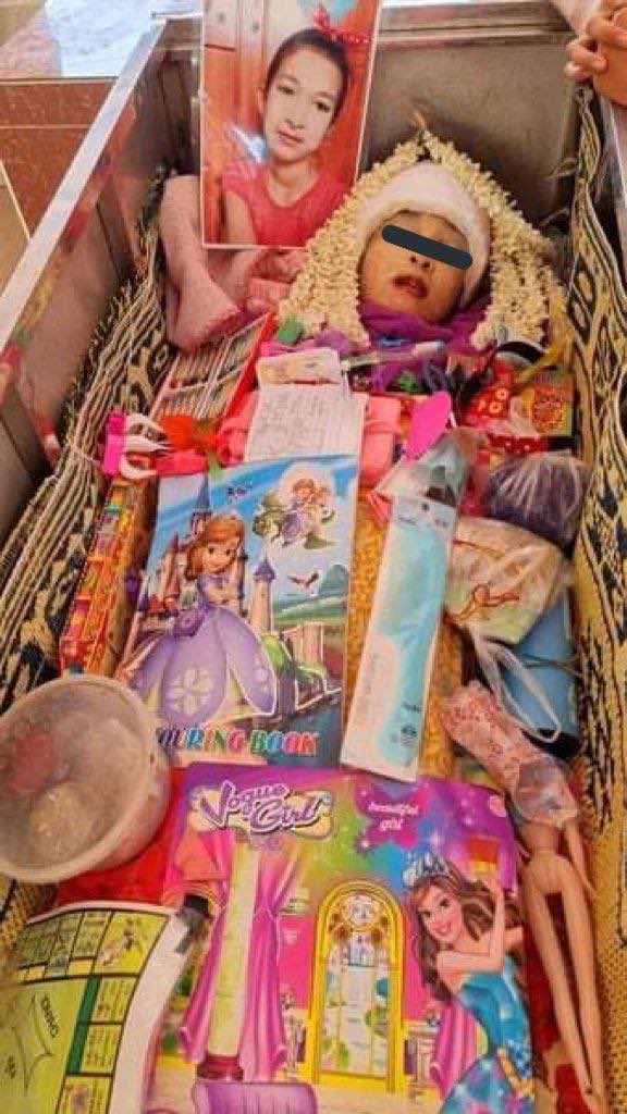 YungVictor7's tweet photo. Funeral of a 11 years old girl who was killed yesterday by military terrorists was held today. Colour pencils and drawing books are seen in the coffin of a drawing loving child.
JUNTA MASSACRE 
#WhatsHappeningInMyanmar  
#Mar28Coup https://t.co/kSfUhJprFr