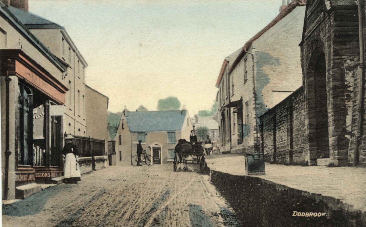 C. 1890 view taken from a tinted postcard, looking north up Church Street. A provision shop on the left, later the Kingsbridge Steak House and now converted to houses, and the old British School on the right (P04702).