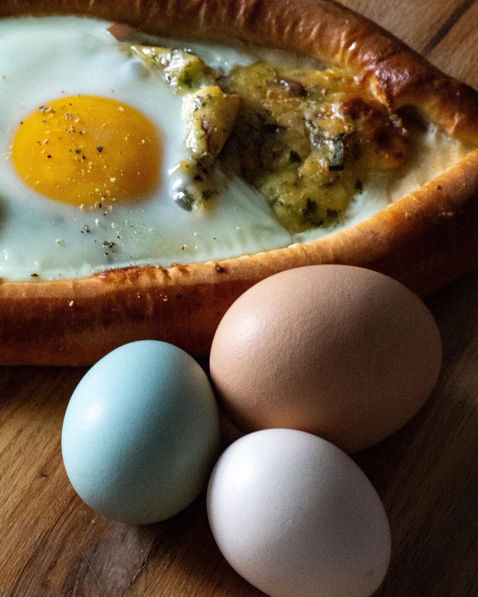TulipStKitchen's tweet photo. A feta, ricotta, and gouda stuffed Adjarian Khachapuri seasoned with chives and parsley and topped with a beautiful green egg to celebrate the Greenland Shark for March’s #animalbread. 

#tulipstreetkitchen https://t.co/jKHzNie2a6