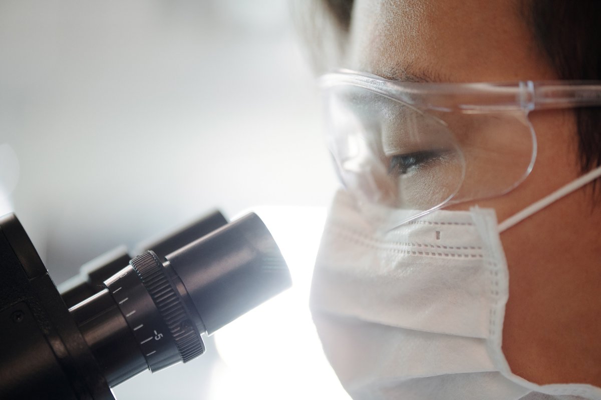 Scientist looking through microscope