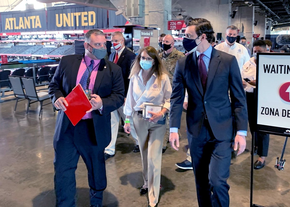 Group of people are lead through the MB Stadium. Atlanta United on an overhead sign.