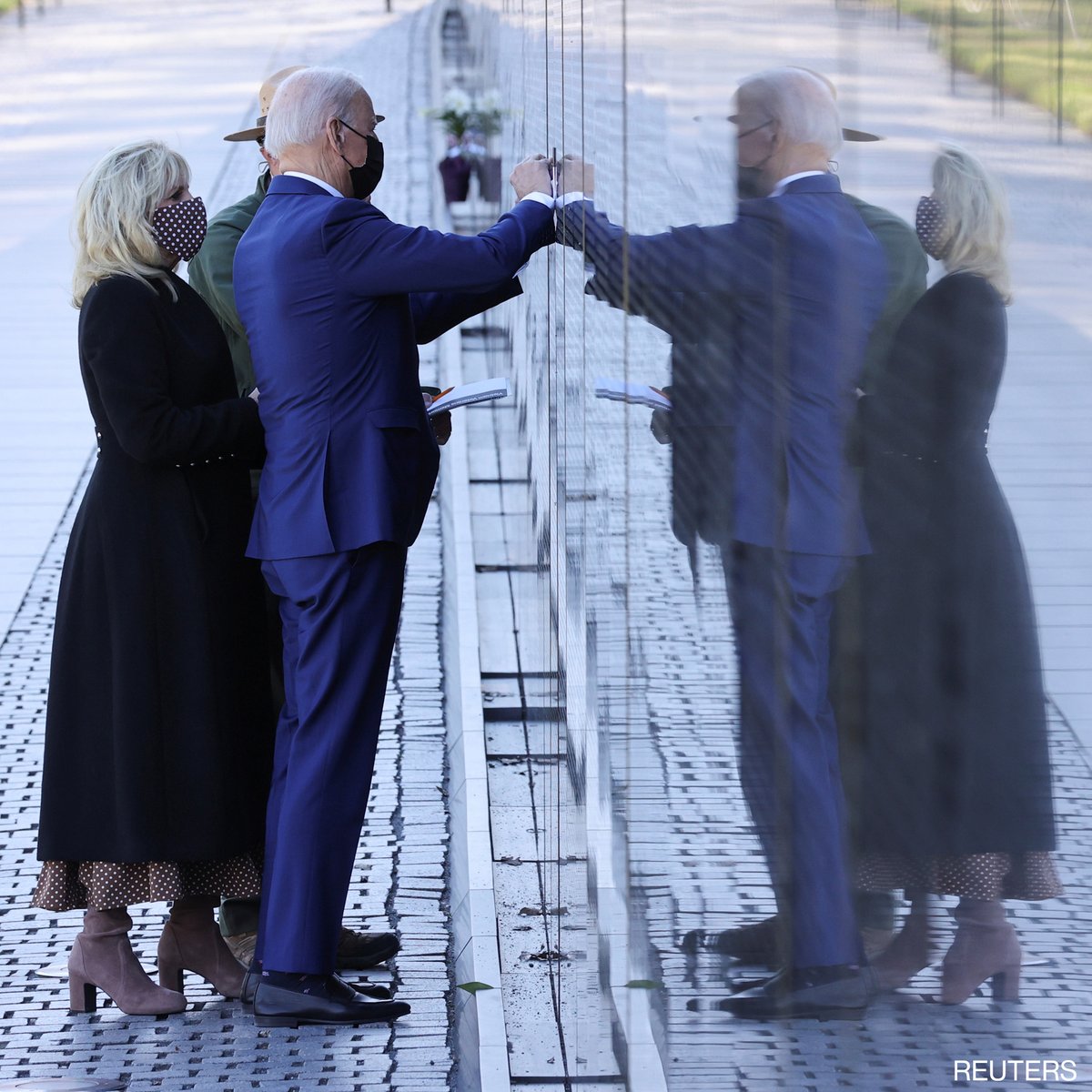 ABC's tweet photo. Pres. Biden and first lady Dr. Jill Biden visit the Vietnam Veterans Memorial in Washington, D.C., to mark National Vietnam War Veterans Day. https://t.co/CtFGYo1ANg https://t.co/qwRhxY4h1D