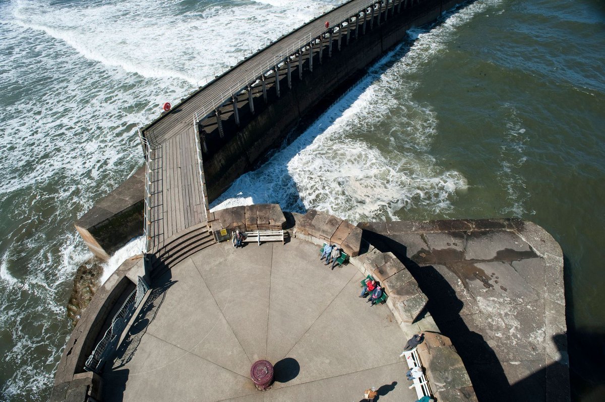 whitbycottage's tweet photo. Aerial view of the West Pier in Whitby  with sea crashing in picture by image: https://t.co/BdqJixS2yC  Whitby Holiday Cottages at https://t.co/98QRL0kK8h https://t.co/tOXrooPVzt