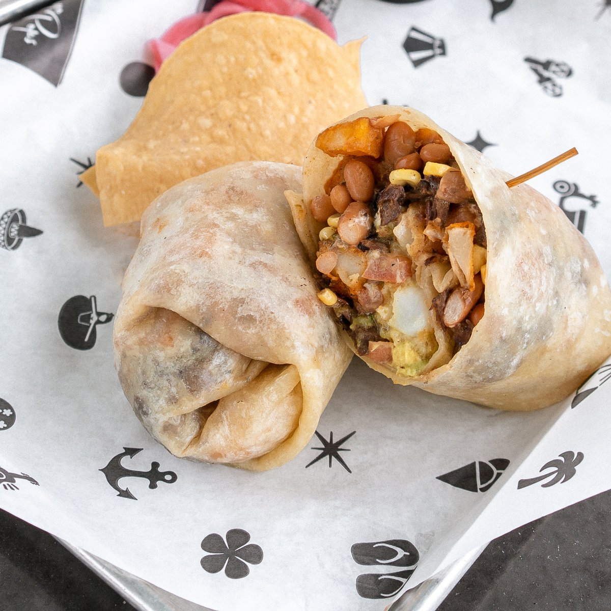 Our California Burrito sounds like a great takeout Tuesday lunch plan! Charred skirt steak, pinto beans, sweet corn, tomato, crispy potato, guacamole, crema.