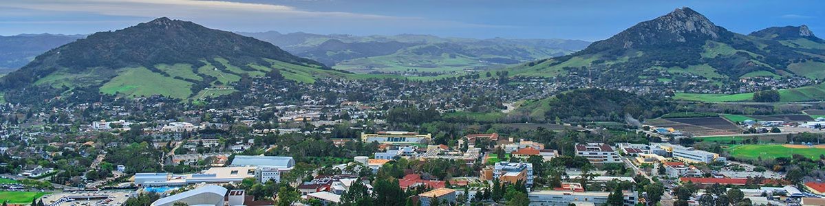 An aerial view of the Cal Poly campus, nestled between surrounding hills. 