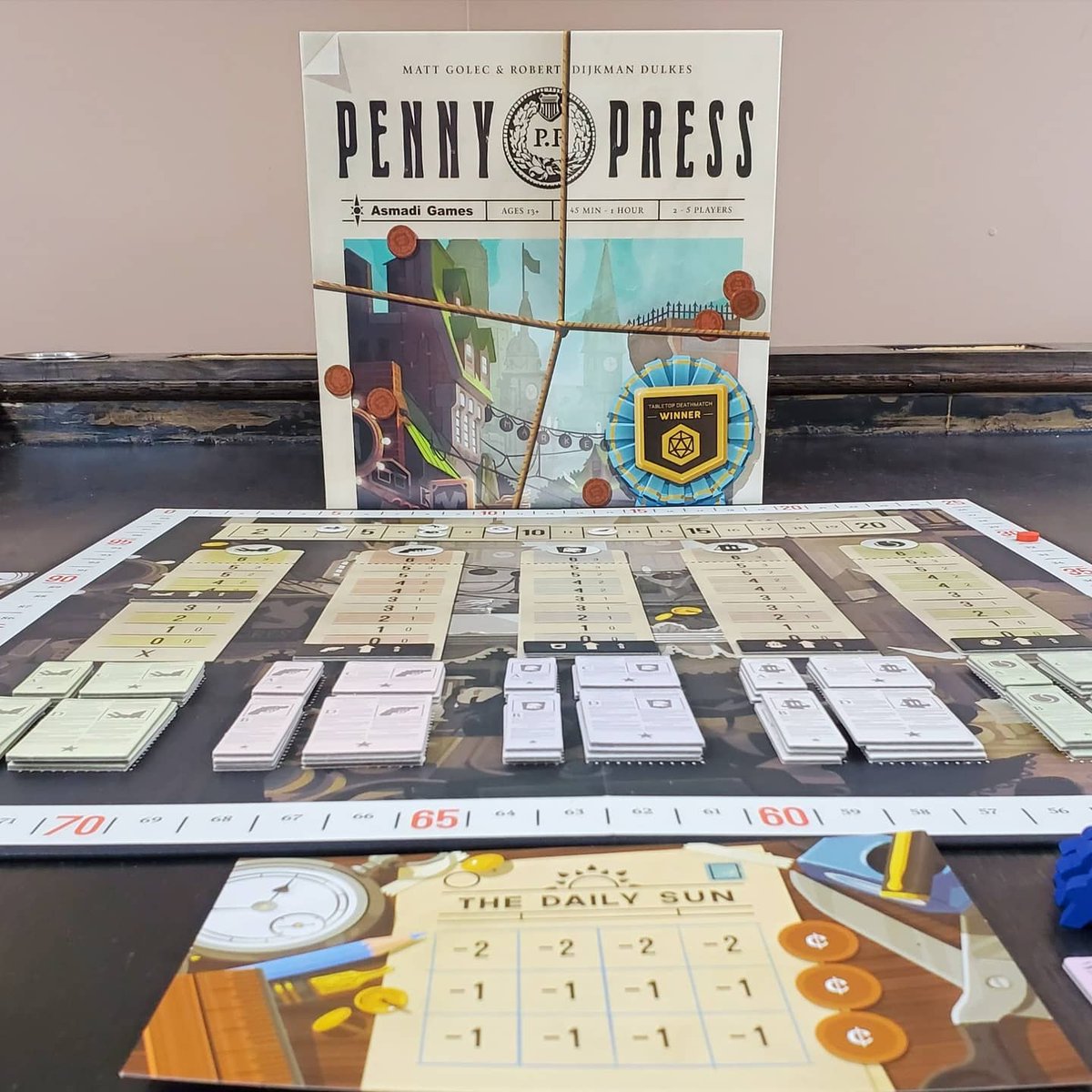 instantgamenite's tweet photo. Extra! Extra! Read all about it! Today we review #PennyPress by @AsmadiGames
⭐ Total Game Night! Score: 9/10 👍👍
Check out our full review at https://t.co/qGFrtg5ggq
#pennypress #asmadigames #workerplacement #areamajority #areacontrol #boardgamegeek #boardgames https://t.co/4wgj2Z7uRk