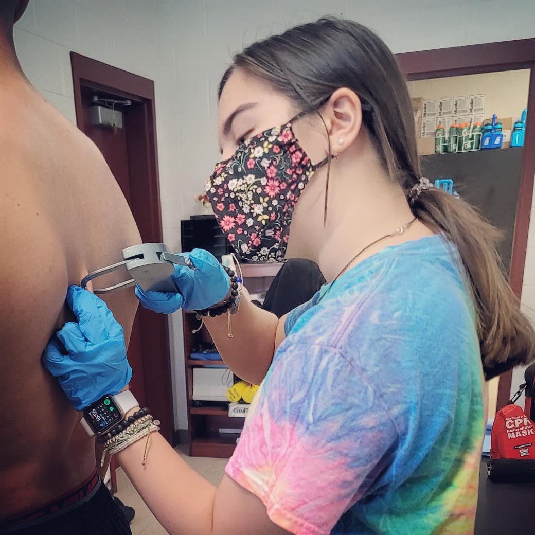 HokeSportsMed's tweet photo. Senior Sports Medicine Student Assistant practicing skinfold caliber testing as we prep for wrestling season @HokeCountyHS @HokeAthletics #buckslearning https://t.co/NXcspgrTBG