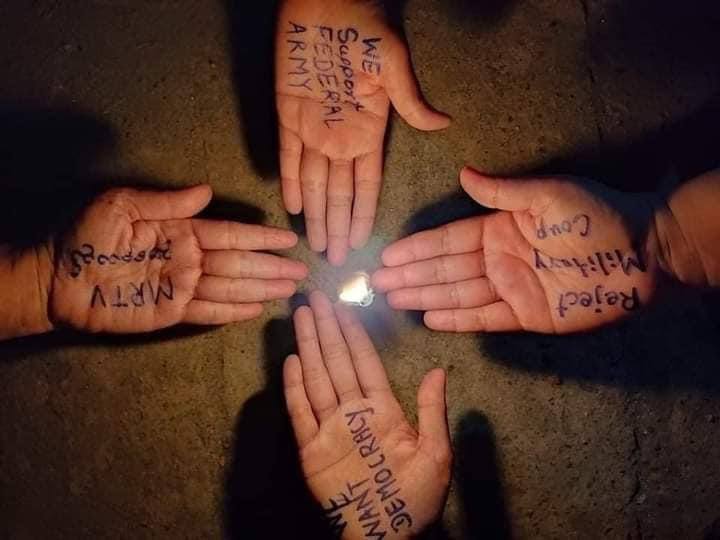 Merries12494's tweet photo. Night strike with a demonstration, words against military regime written on palms in Mudon town, Mon State. 
#Apr13Coup 
#WhatsHappeningInMyanmar https://t.co/NSI9OpymEC