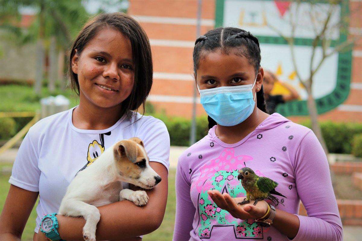 Sisters Mariallne, 14 and Mariana, 16, show me their pets they brought along. They recalled hearing helicopters and then loud explosions before they fled. They said the electric went off and people ran away. The dog is called Niño (it was a popular choice) and the bird is Purri.