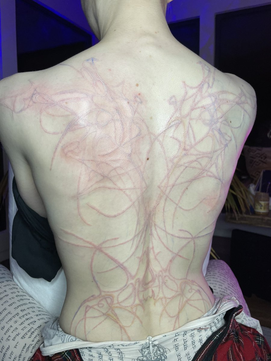 Grimes Debuts New Gnarly WhiteInk Alien Scars Full Back Tattoo