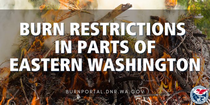 A fire burns with text overlay that reads: Burn restrictions in parts of eastern washington.
