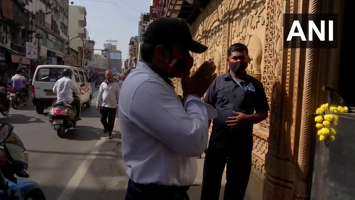 ANI's tweet photo. Maharashtra: All religious places in Pune to remain completely closed till April 9th in the wake of the #COVID19 situation. Visuals from Shreemant Dagdusheth Halwai Ganpati Mandir where people pray outside as the temple remains closed. https://t.co/94M1pXDV5u