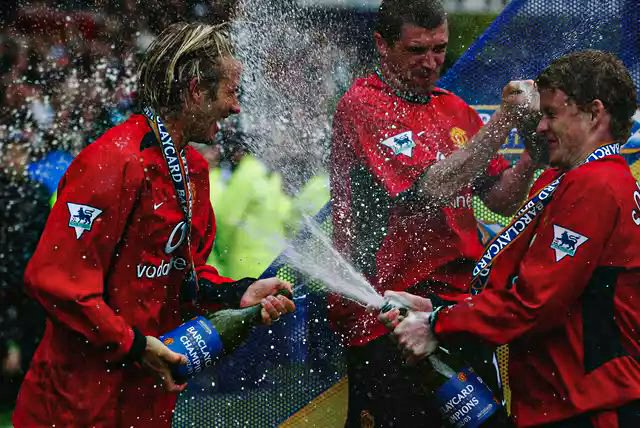 Beckham, Keane and Solskjaer celebrate with champagne as United are crowned English Champions for an 8th time in 11 years, May 2003.