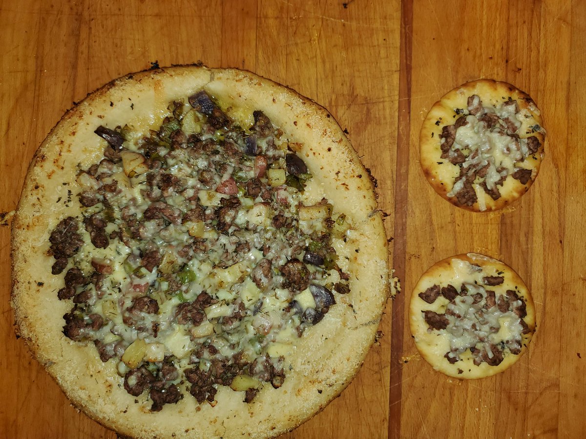 Rakoonin's tweet photo. What would the name of this? It is a homemade pizza crust with Welsh Oggie ingredients: mint-infused olive oil, lamb, thyme, potatoes, and Caerphilly cheese. Poggie? Ozza? #welshcooking #cyrmu https://t.co/mJ22iXaS2A