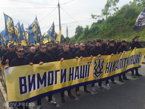 The narrative seems to be that Azov is the willing and eager arm of the fascist Kyiv junta.The reality is, of course, more complicated.Azov is a multi-faceted far-right movement. Its political wing, the National Corps, regularly protests against the government.