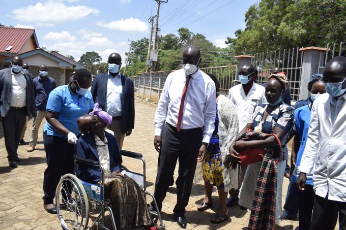 Bungoma Governor Wangamati (centre) picks Mama Beatrice Makokha from her Kamusinde home in Kimilili Sub County and for medication at Bungoma County Referral Hospital.