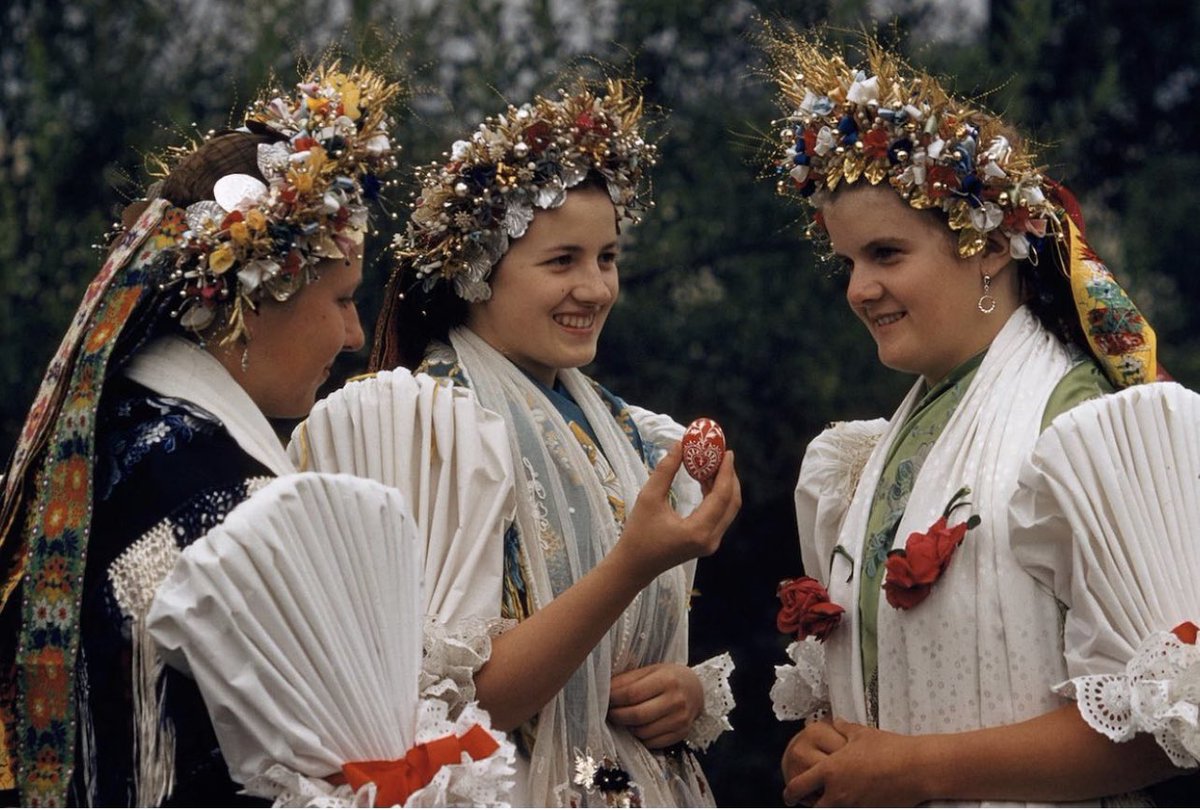Happy Easter 🐣 🐰🐣 • Women in traditional dress share eggs that say “Happy Easter” in German. The photo, taken in Stinatz, Austria by 
Volkmar K.