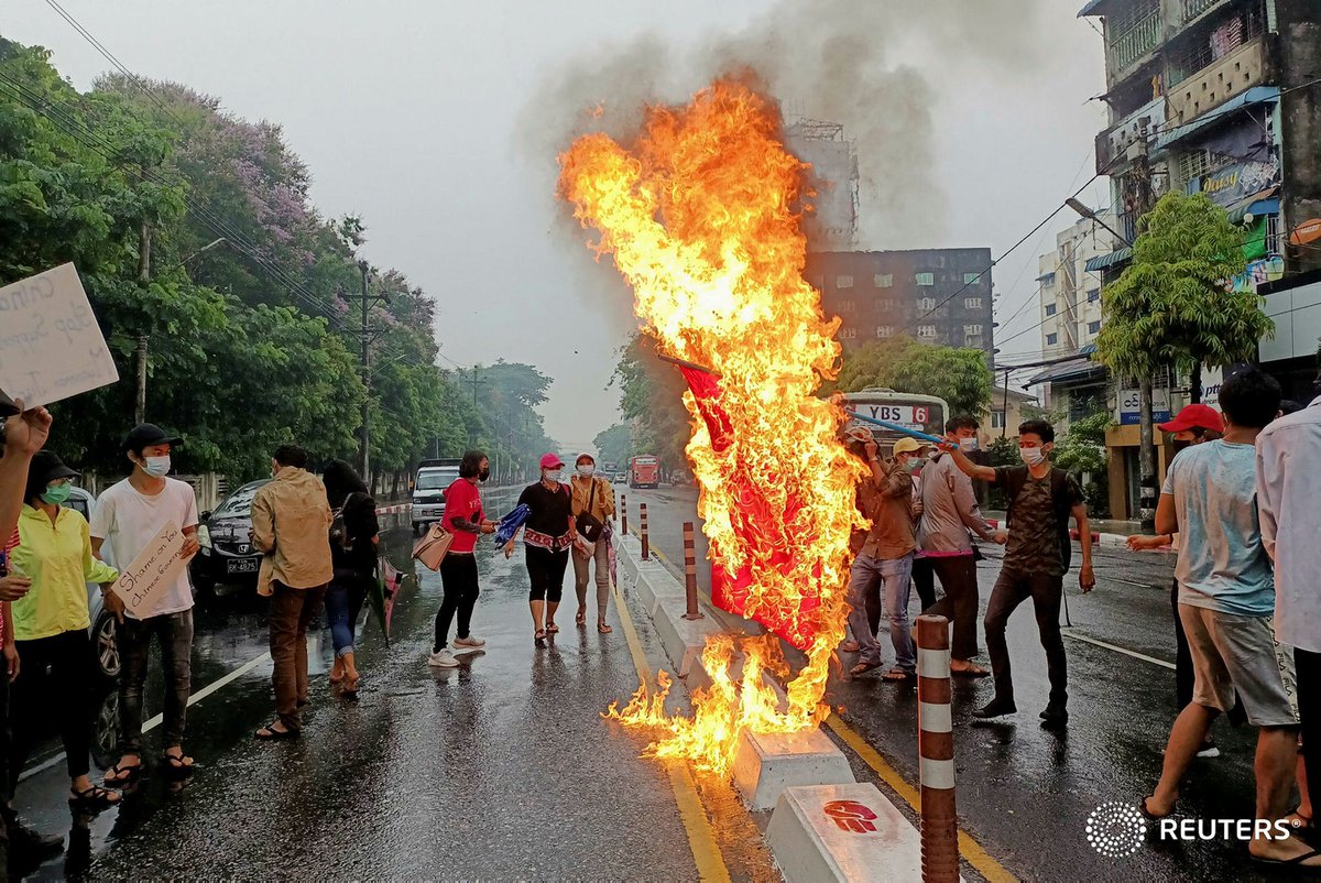 Anti-coup protesters burn a Chinese flag in Yangon, Myanmar  April 5, 2021. REUTERS #WhatsHappeninglnMyanmar