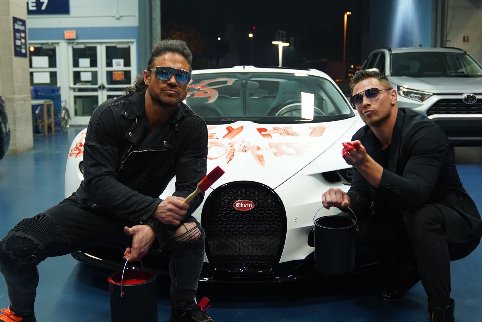 John Morrison and The Miz with a defaced Bugatti owned by Bad Bunny on WWE RAW.