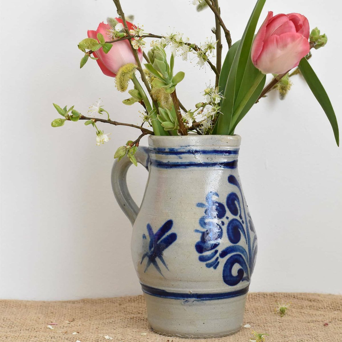 These grey and blue salt sandstone jugs are perfect for showing off an informal arrangement of homegrown and foraged Spring flowers. The decorative blue glaze detail has been created by using cobalt oxide. Both of these are available to purchase from our website - link in bio.