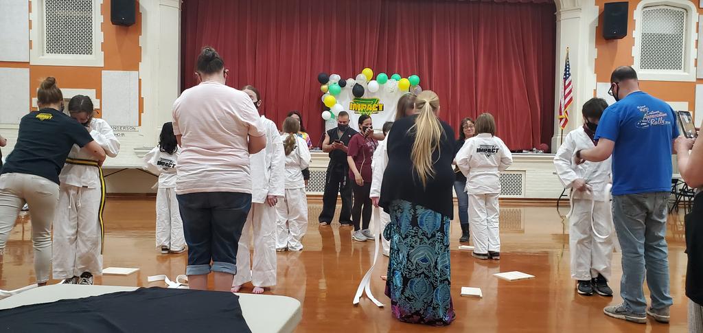 Tim47Carr's tweet image. So cool parents helping their children apply yellow belts they have achieved. #WilsonAfterSchholAdventures