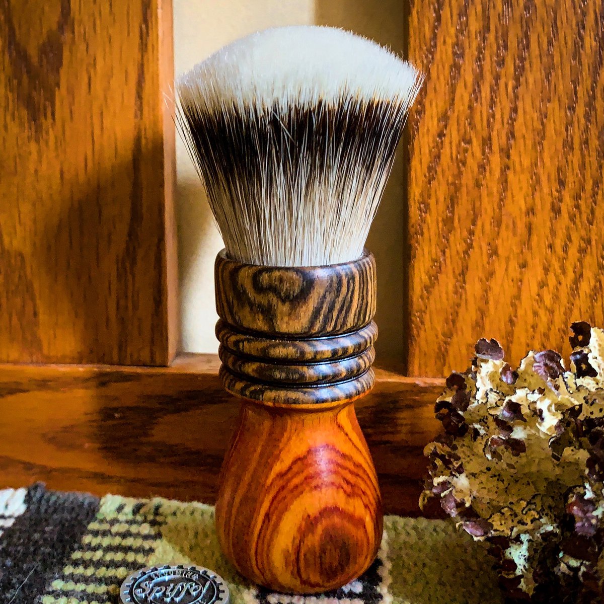 Santini features a ferrule made of Bocote that tops, and complements, the sharply contrasting Canarywood base. The combination of these two exotic woods and the super high-density 24mm High Mountain White fan style knot creates a shaving brush that is a classic as it is unique!
