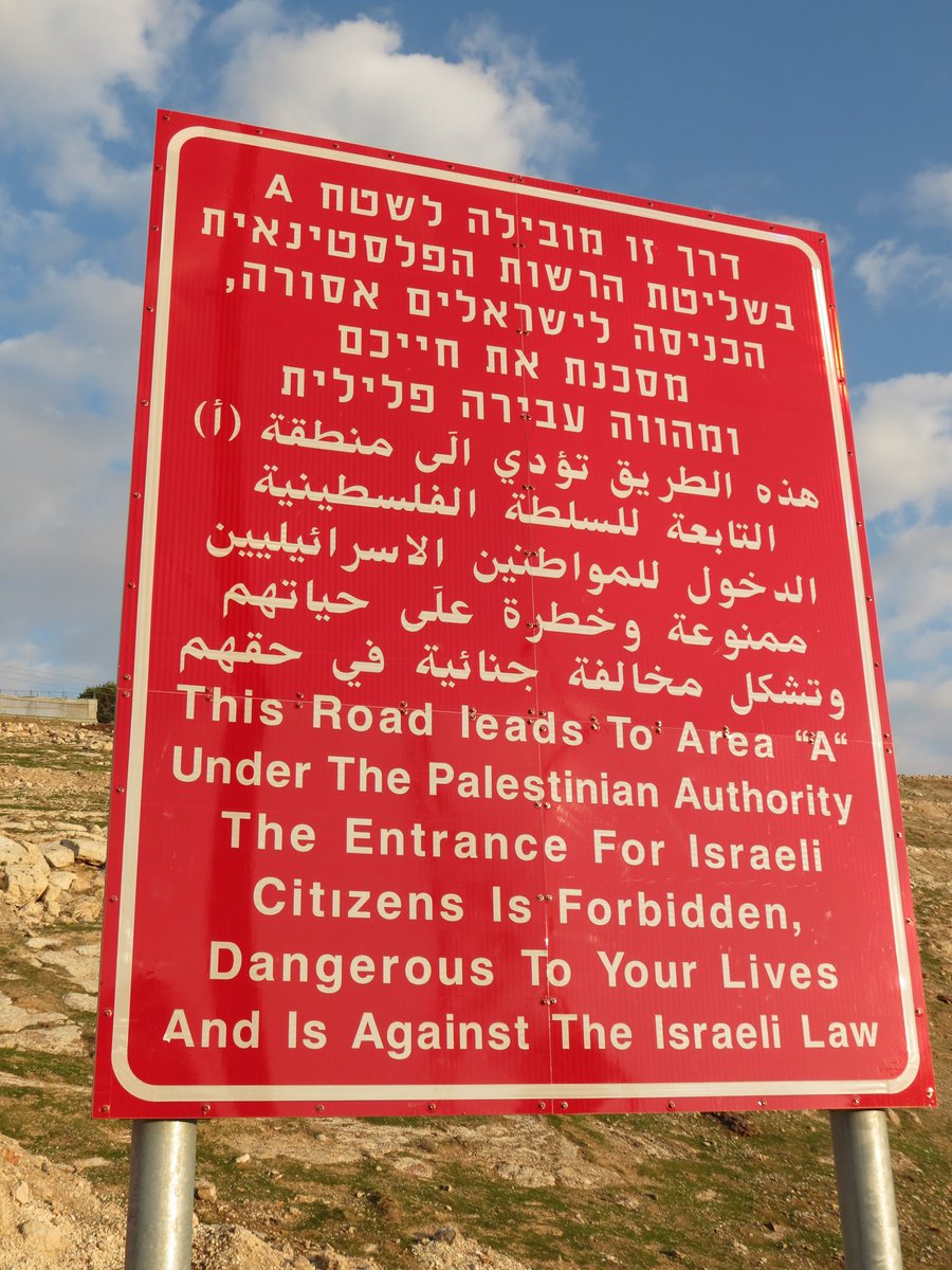 Another version of the sign here - can you tell what is missing in the image posted by  @GoldsteinBrooke yet?Yep. That’s right - the signs omit reference to it being the Israeli law that forbids Israeli Jews from entering the Palestinian areas of the West Bank 