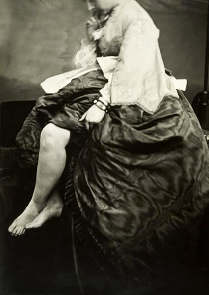 A number of photographs depict her in poses risqué for the era — notably, images that expose her bare legs and feet. In these photos, her head is cropped out.