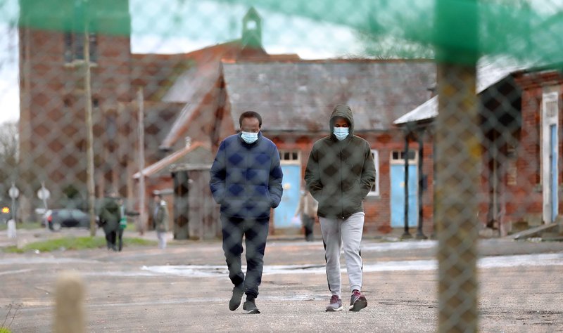 'they're not supposed to be detained. In theory, their accommodation should allow them outside at any time. But even pre-COVID, residents lived with security guards on the gates, a barbed-wire fence around the perimeter, a curfew, and were only allowed out for 2 hours at a time'