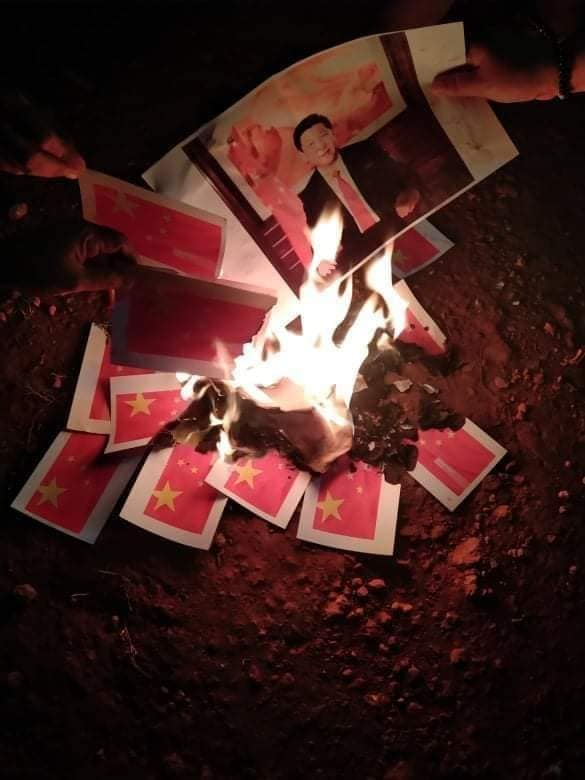 HninJeon's tweet photo. Mudon citizens burned the china flag &amp; photos of Xi Jinping for the abhorrent actions of #CCP who's helping dictators who killed innocent lives brutally. 
Dictators help Dictators.
#CCP_is_terrorist #MilkTeaAlliance 
#WhatsHappeningInMyanmar 
#Apr10Coup https://t.co/vSF5uzlJa6