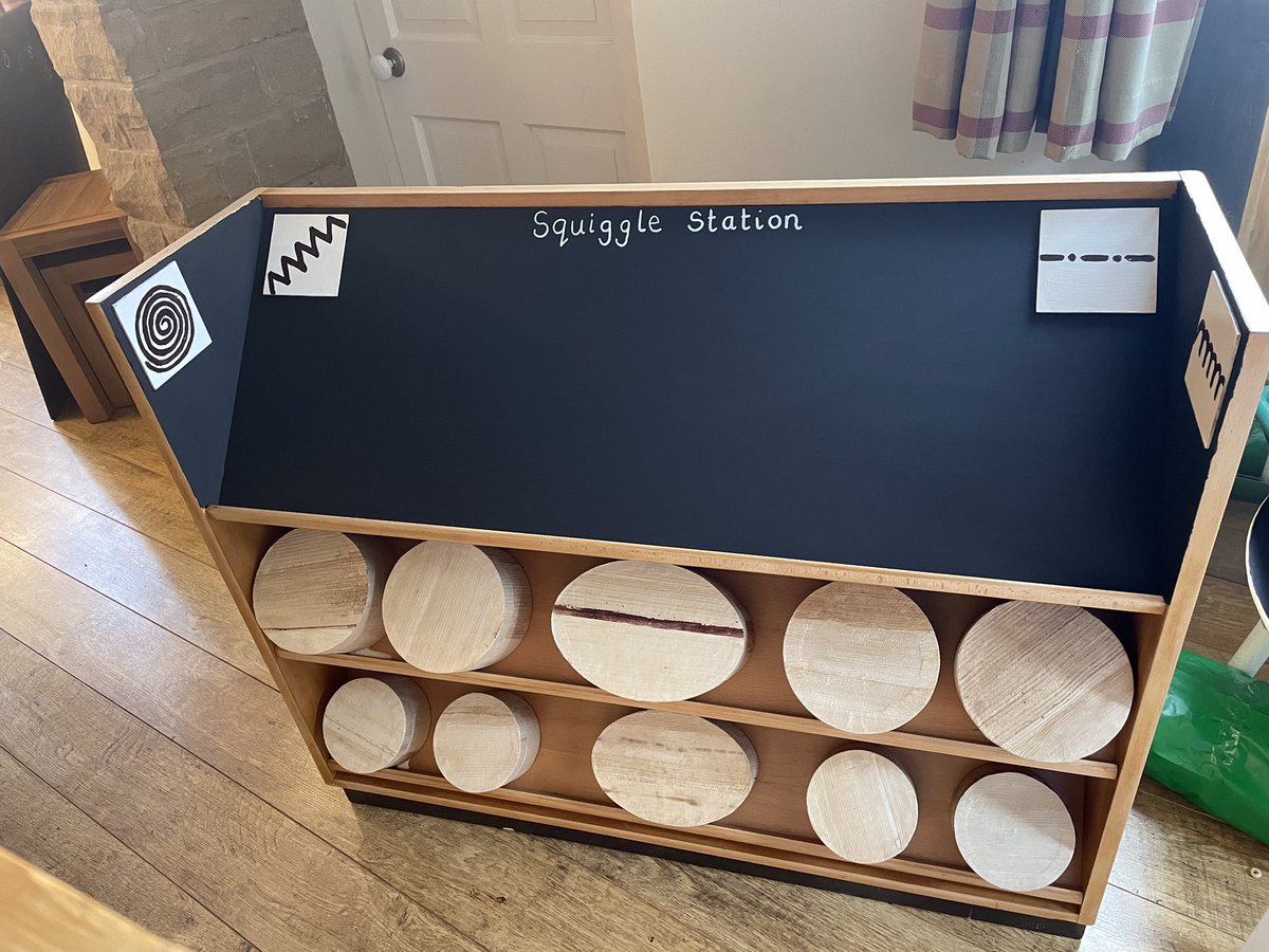 Lg025's tweet photo. I have finally finished my squiggle station. One old unit saved from the school skip and sanded down. Chalkboard paint or varnish added and tubs to put mark making tools in. I now need to take everything back to school and clear my house. #Squigglewhileyouwiggle #EYFS https://t.co/CtvMSQL4eu