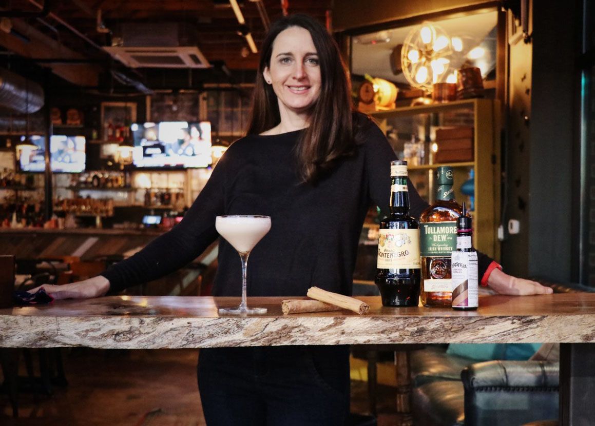 Our Head Bartender Ashley Sarkis is the genius behind our newer cocktails. She brings 21 yrs. of experience to the team &amp; has bartended in major cities - Atlanta, Austin and CLT. After work you can catch her instructing fitness classes and hanging with her husband, son &amp; 4 dogs.